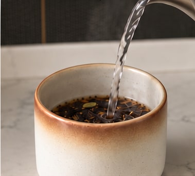 Just-boiled water poured over the chai